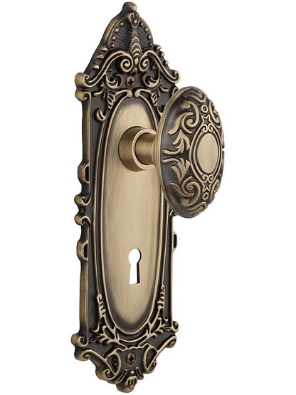 Largo Door Set with Decorative Oval Knobs and Keyhole Single Dummy in Antique Brass.